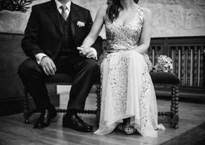 bride and groom sat down holding hands