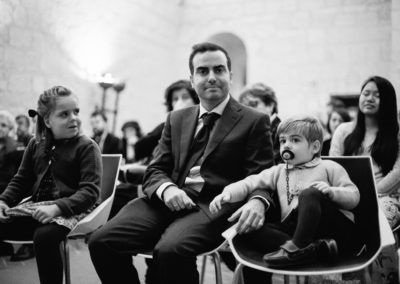father and two children sat on chairs at a wedding