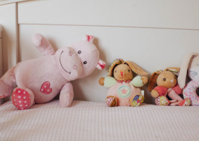 teddies on the end of a bed