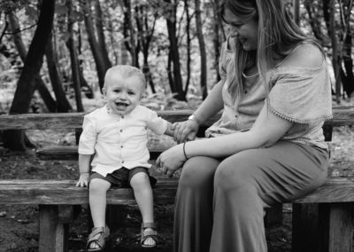 mother and son sat on bench in formally