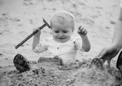 toddler playing in the sand on southport beach