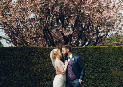 bride and groom kissing on lawn
